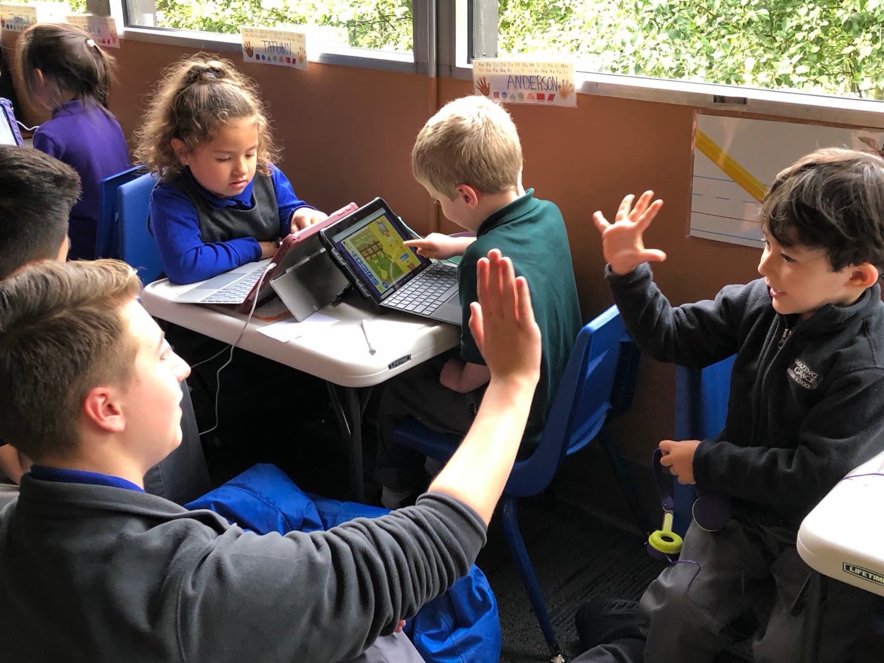 Teacher leading a morning lesson with students seated on the floor